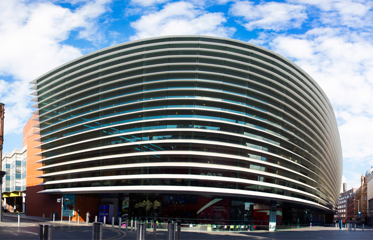 photo of the front of Curve theatre taken from the cultural quarter with a bright blue cloudy sky