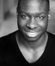 A black and white headshot of actor KM Drew Boateng