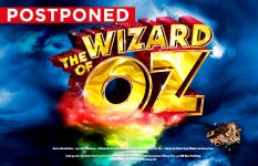 Promotional artwork for The Wizard of Oz with red 'Postponed' banner in top left corner.
