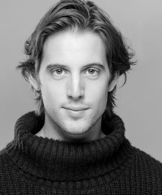 A black and white headshot of Ryan Anderson